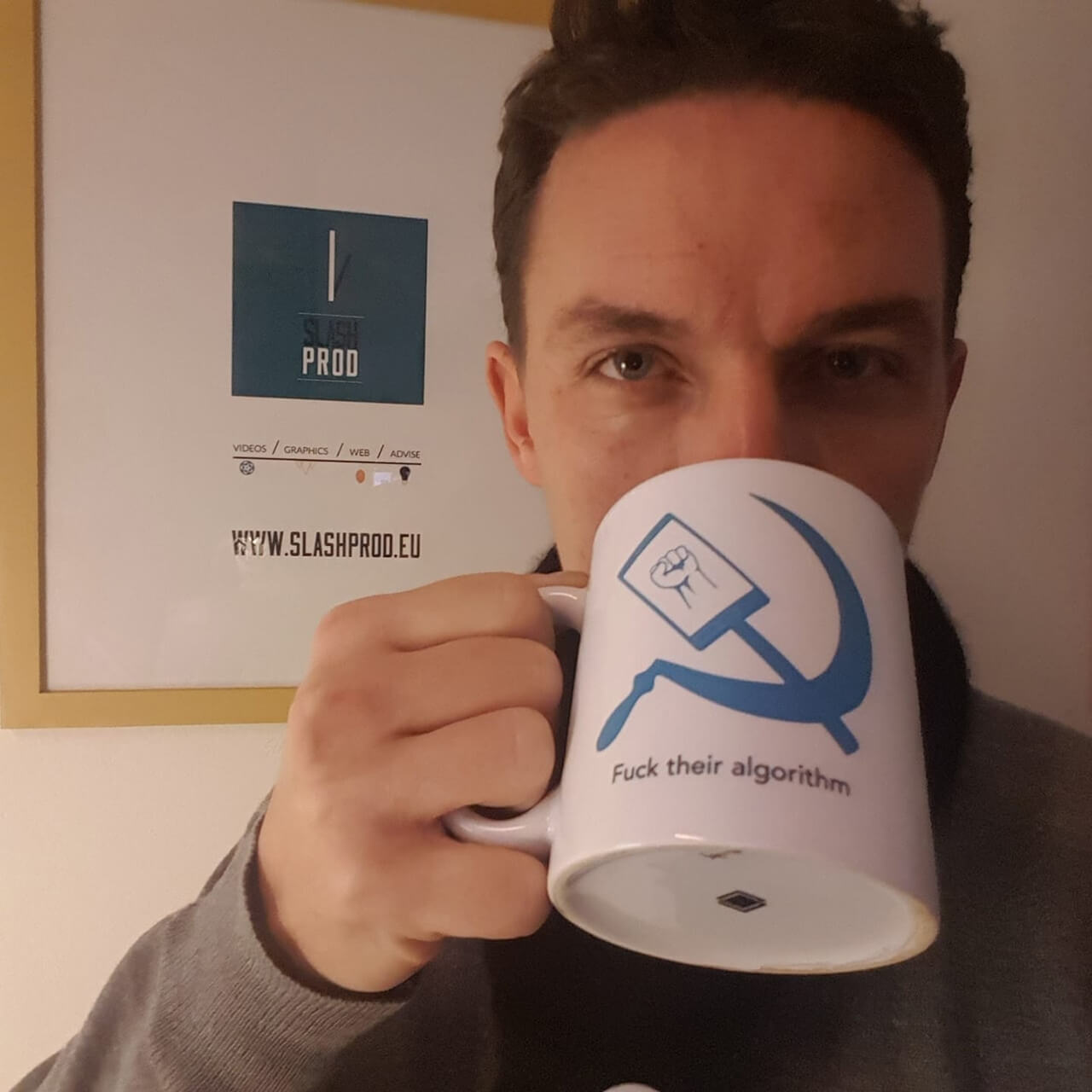 man drinking from a mug